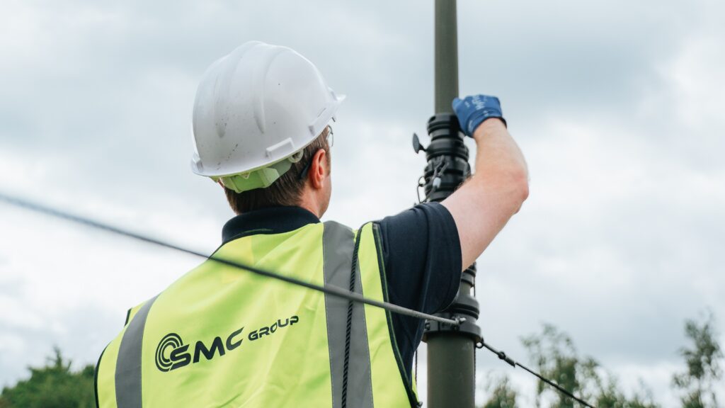 A man is raising a defence mast system from SMC Group