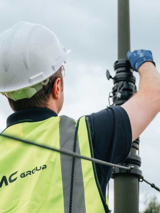 A man is raising a defence mast system from SMC Group